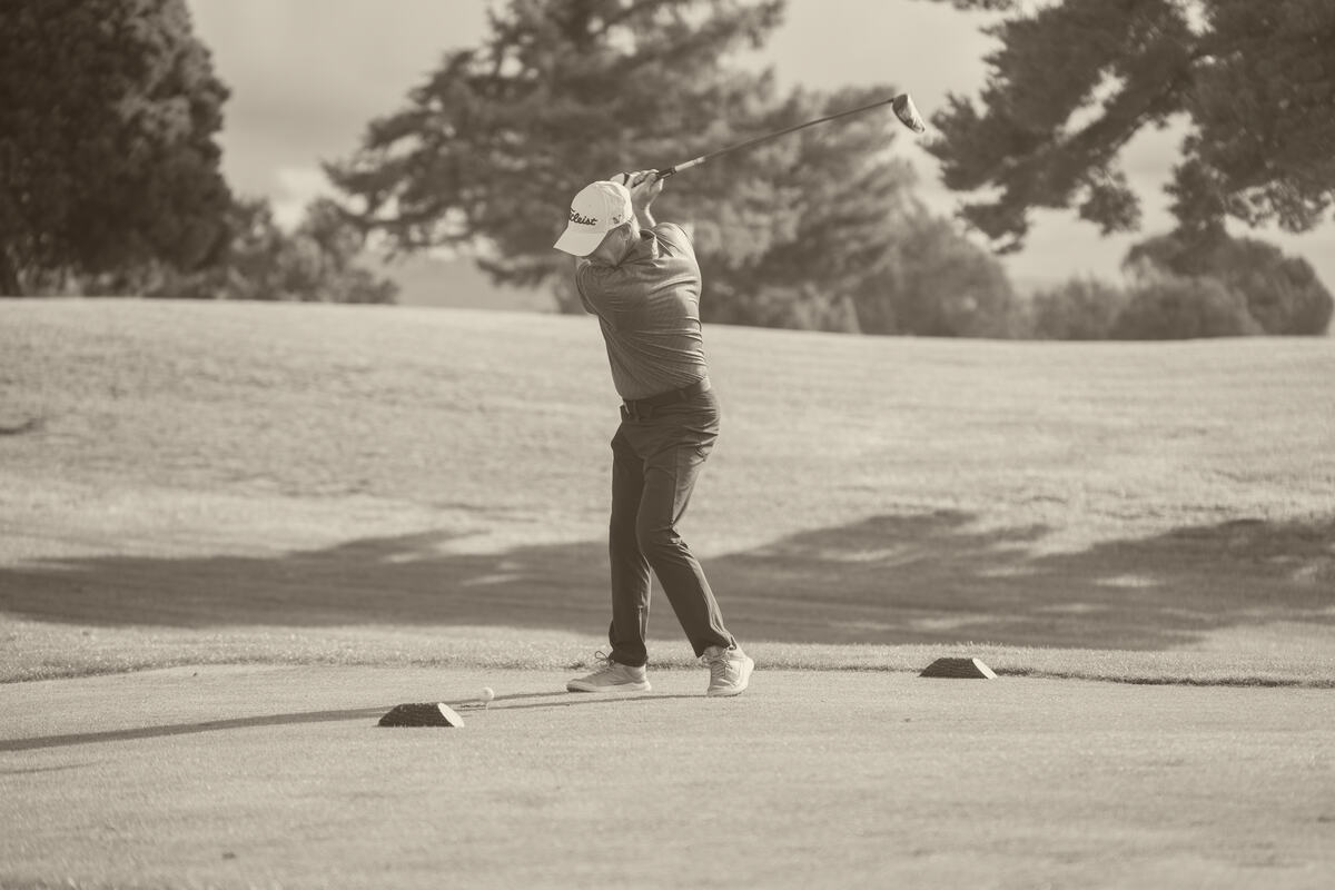 A golfer at address on the tee